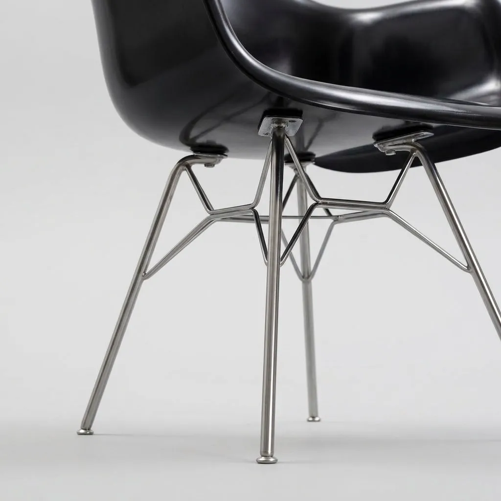 Close-up of the glossy black shell and the chrome rod legs