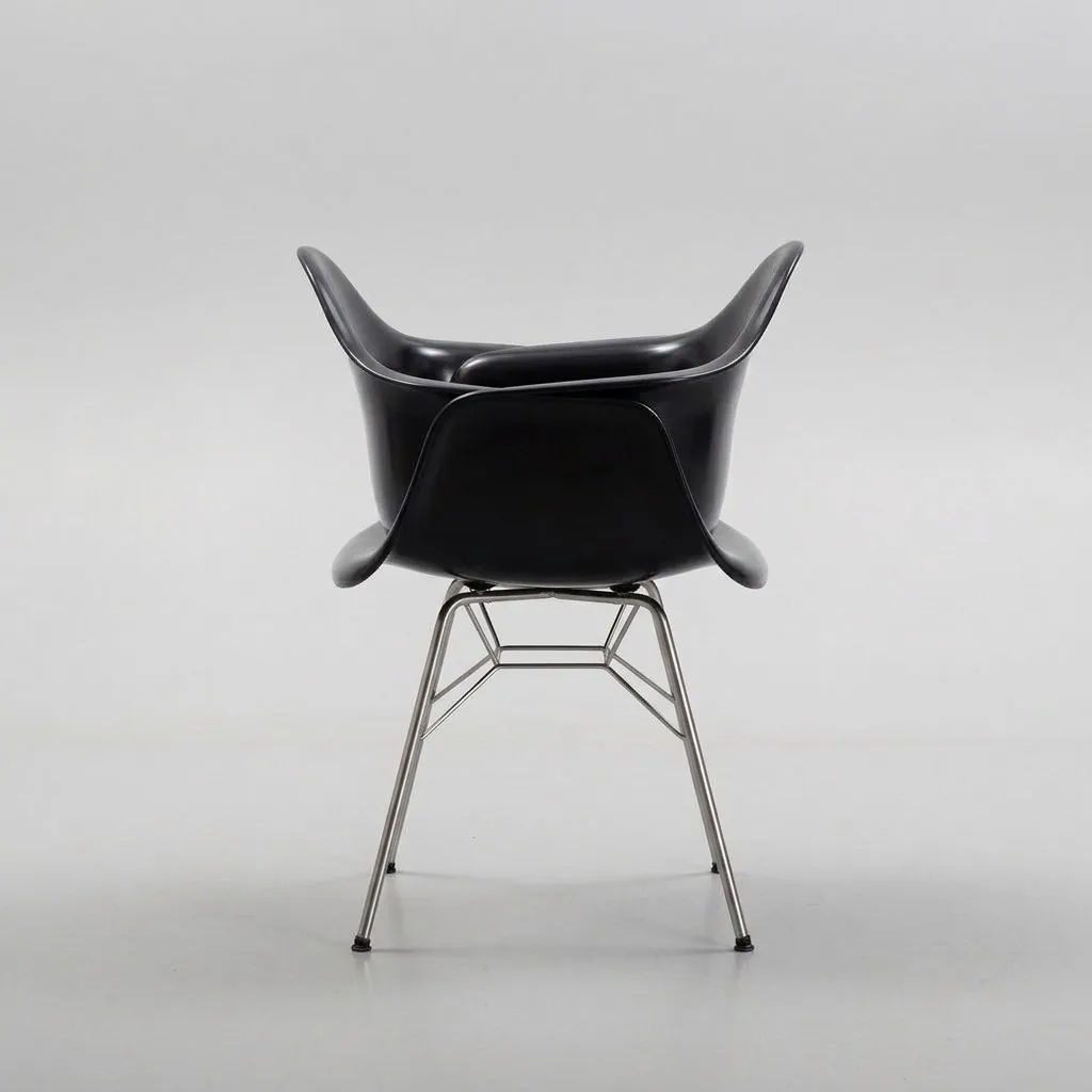 The same armchair in profile, on its chrome rod legs