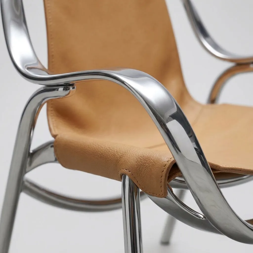 Close-up of the chrome ribbon and the tan leather sling