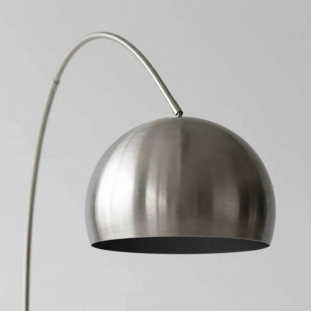 Close-up of the round brushed steel shade at the end of the arc