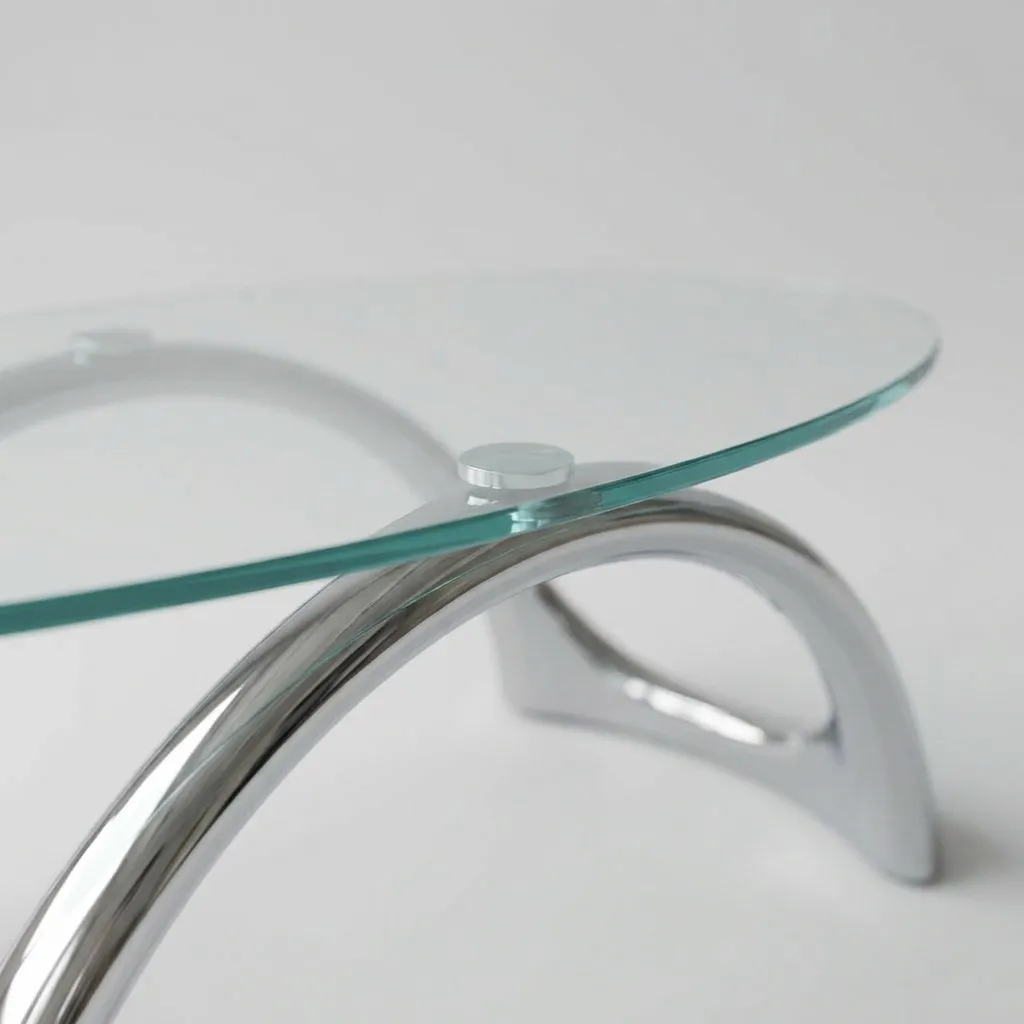 Close-up of the glass edge and the curve of a chrome leg